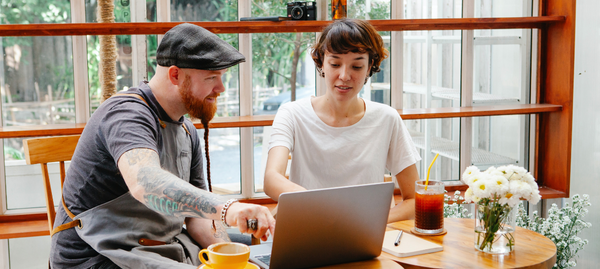 Two people looking at a laptop