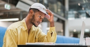 man looking at a laptop